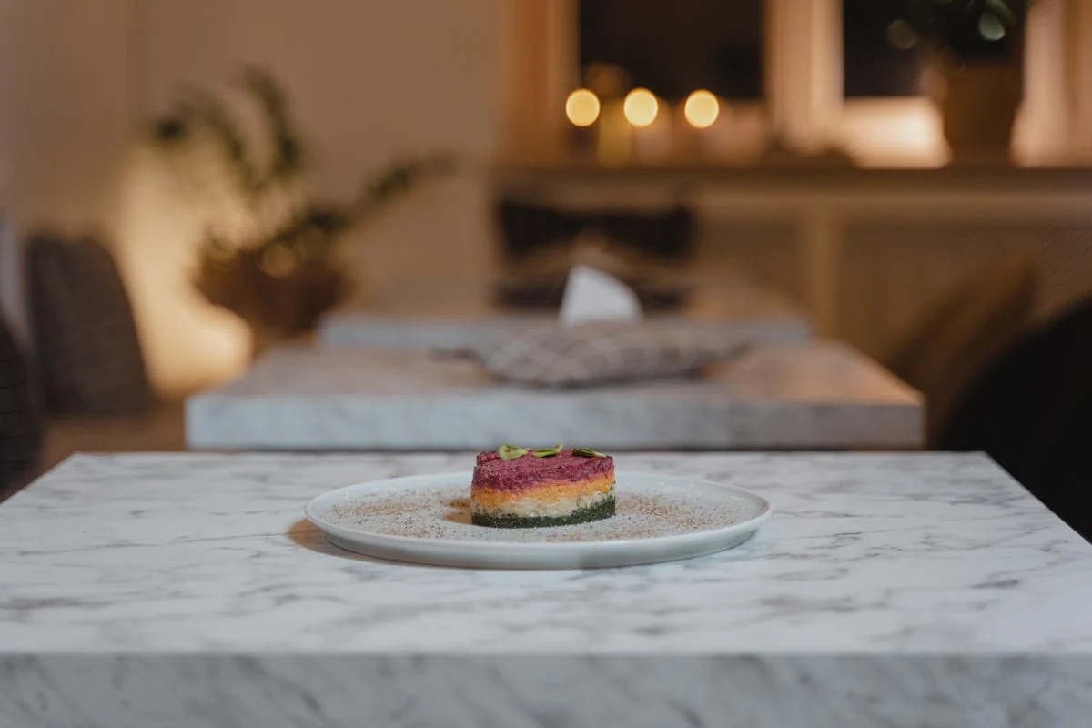Warm restaurant dining room with a plated dish
